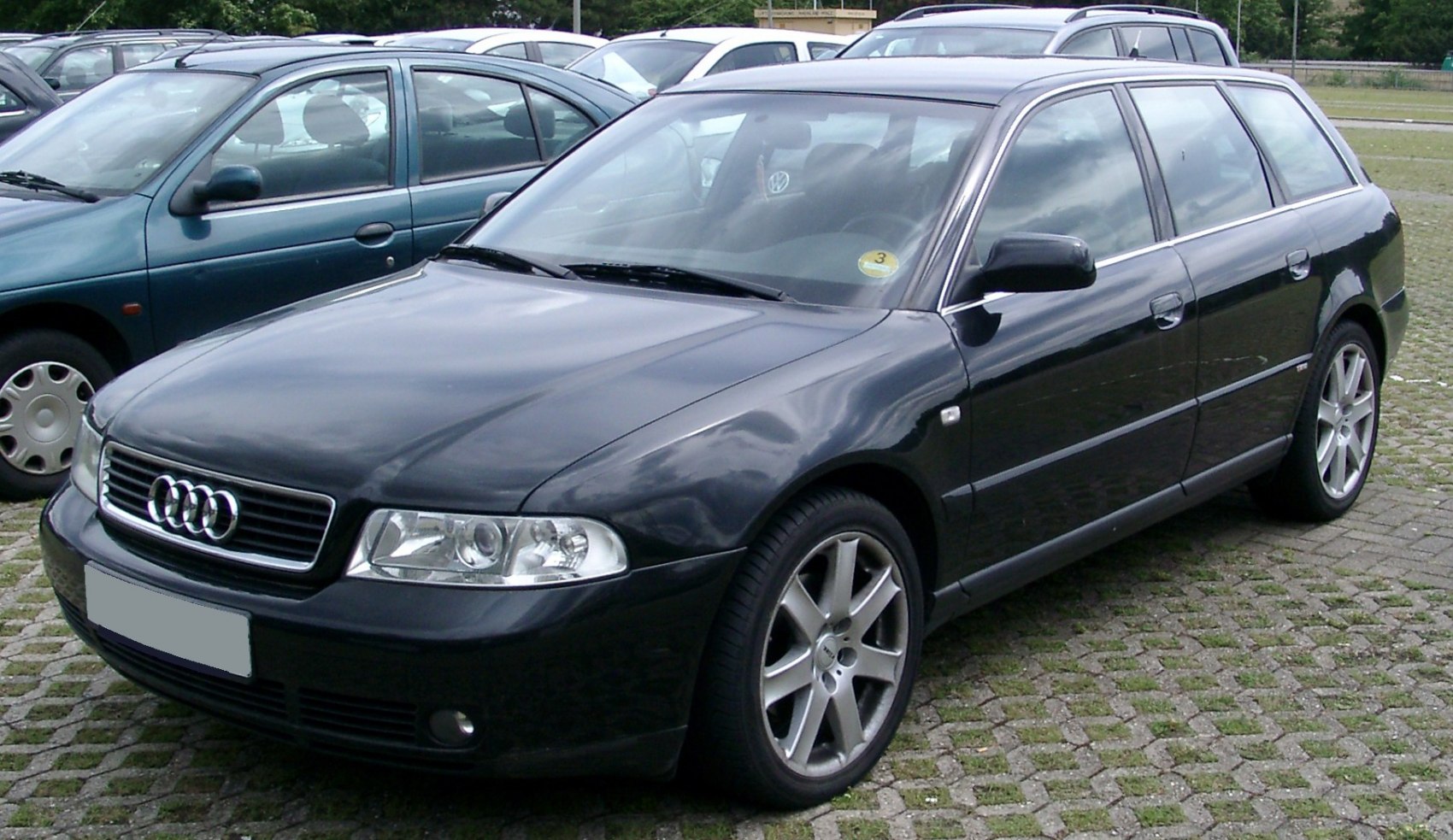 Front and side view of a black station wagon with alloy wheels