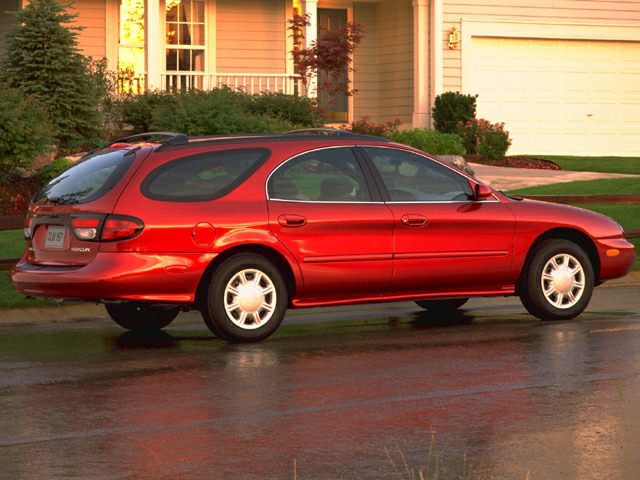 Side profile of a classic elongated rear station wagon with smooth body lines.