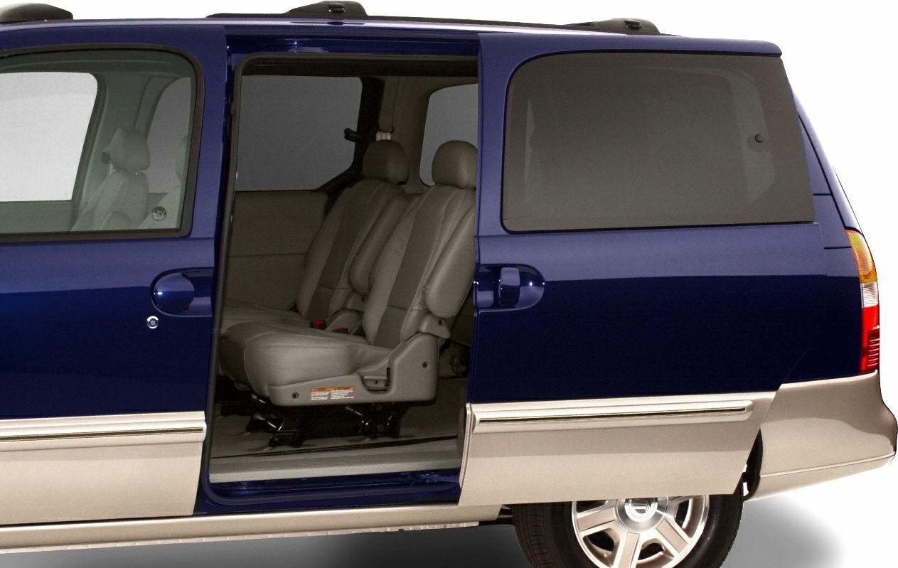 Sliding side door open revealing minivan interior passenger seating.