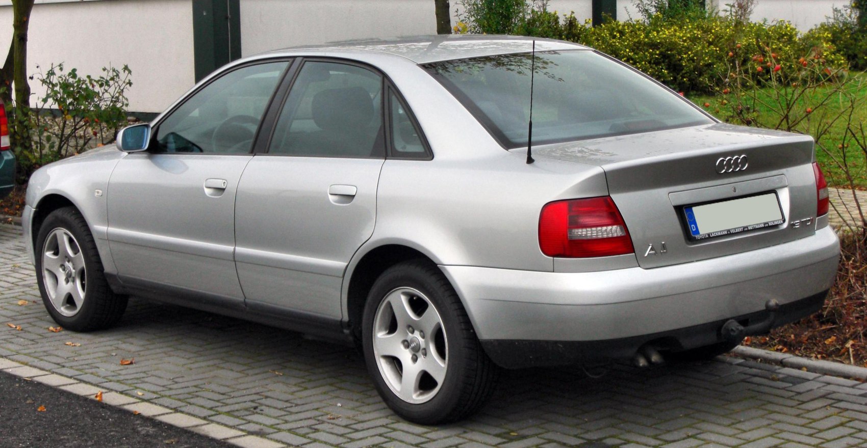 Rear and side profile of a silver mid-size sedan with alloy wheels.