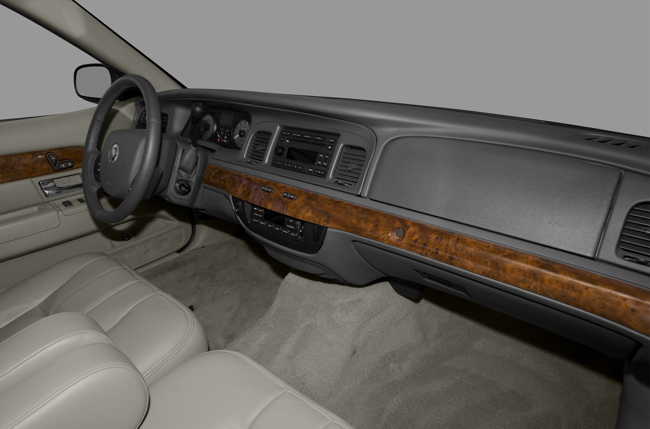 Wood-trimmed dashboard and leather front seats in vintage car interior