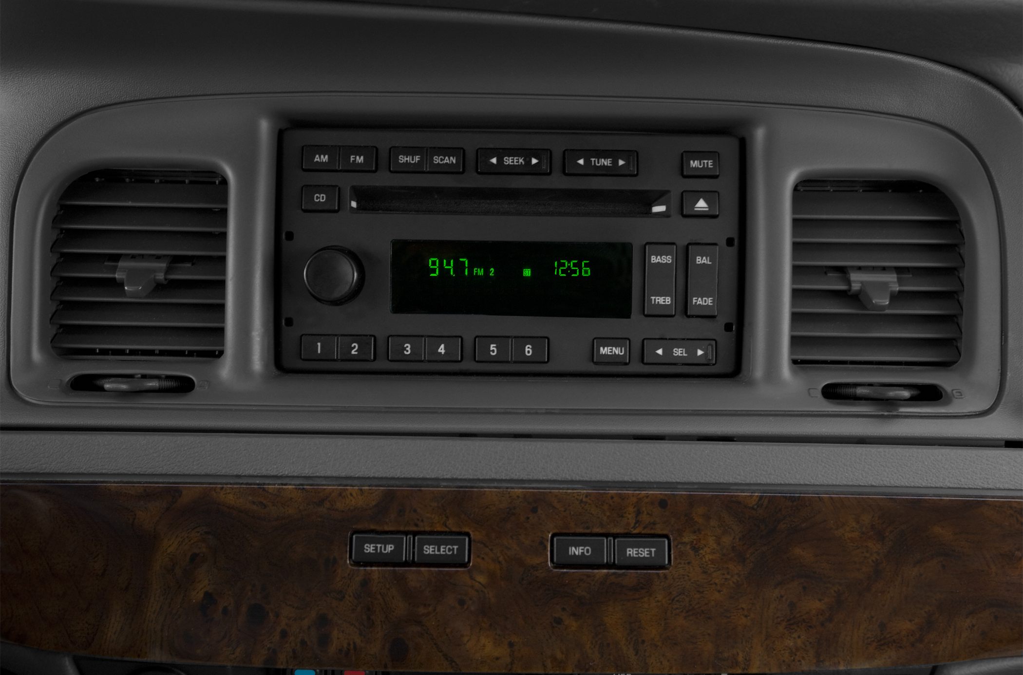 Vintage car radio and air vents with wood trim dashboard