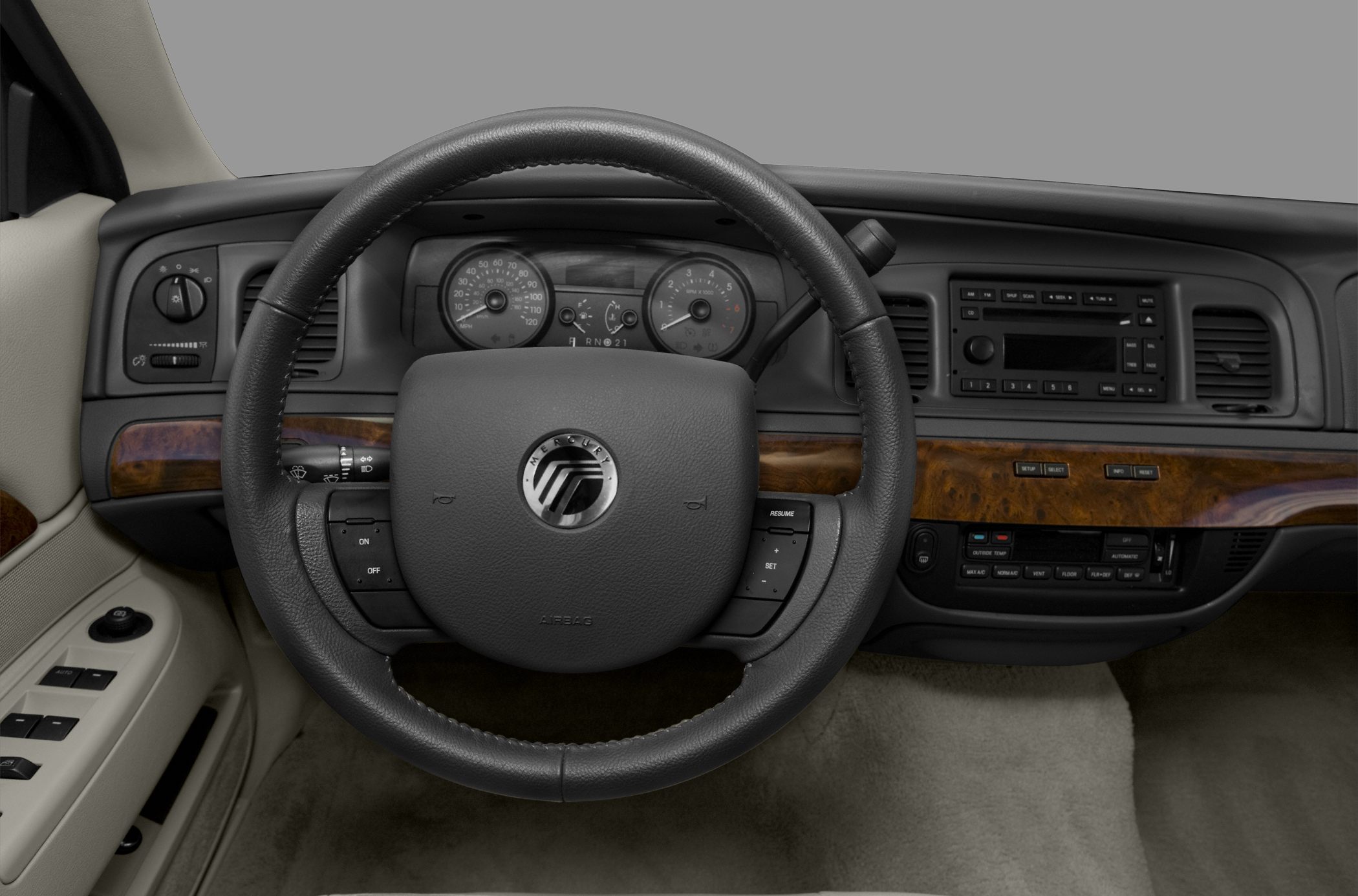 Steering wheel and dashboard with wood trim and instrument cluster