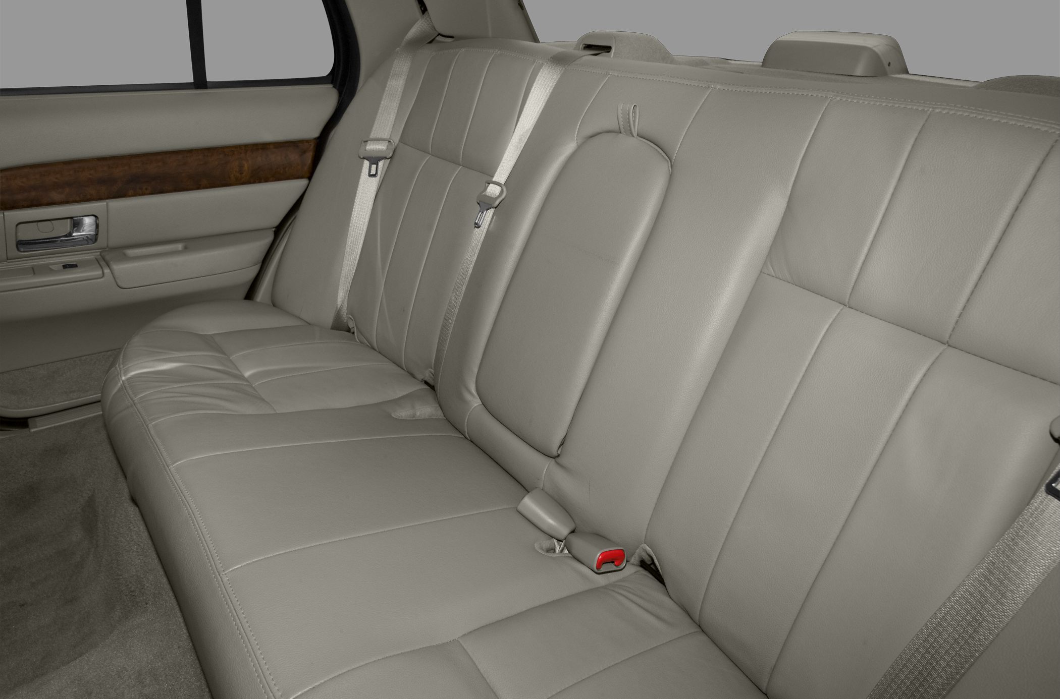 Leather rear seats with seatbelts and wood trim door panel.