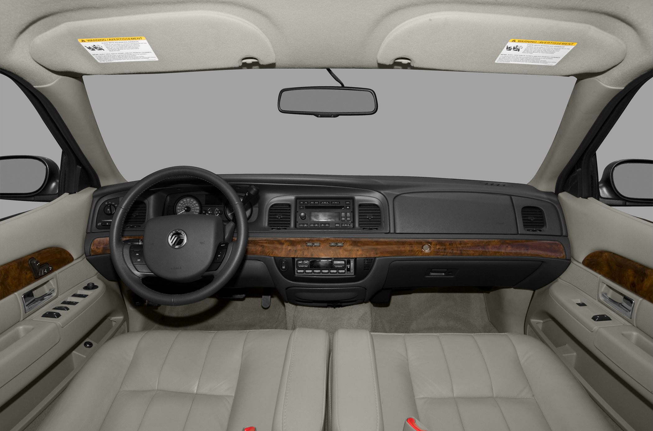 Dashboard and steering wheel with wood trim and beige leather seats