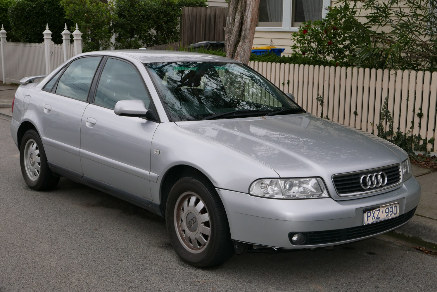 Silver sedan with classic grille and headlight design, front-side view
