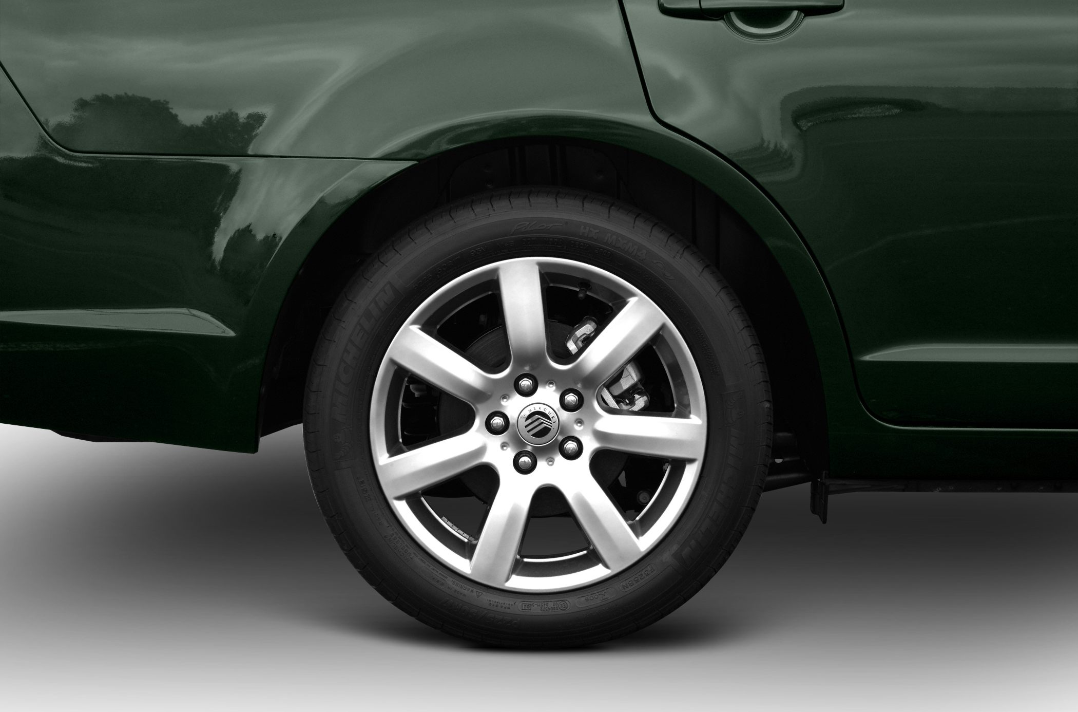 Alloy wheel and rear fender close-up with Michelin tire