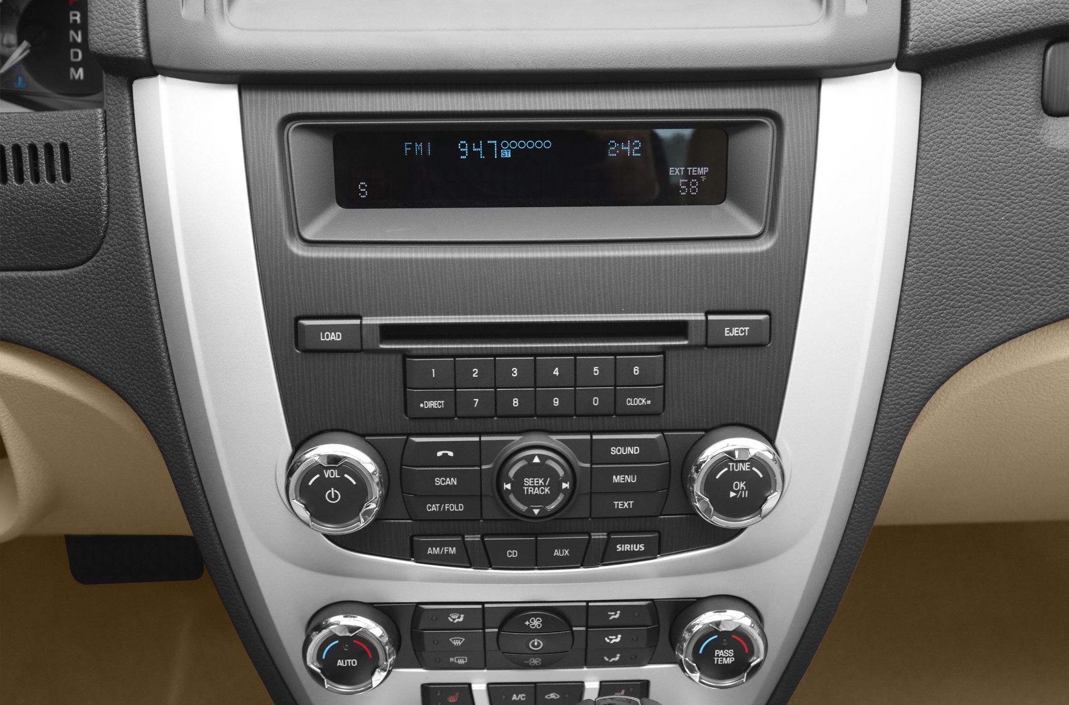 Center console with audio and climate control knobs and digital display