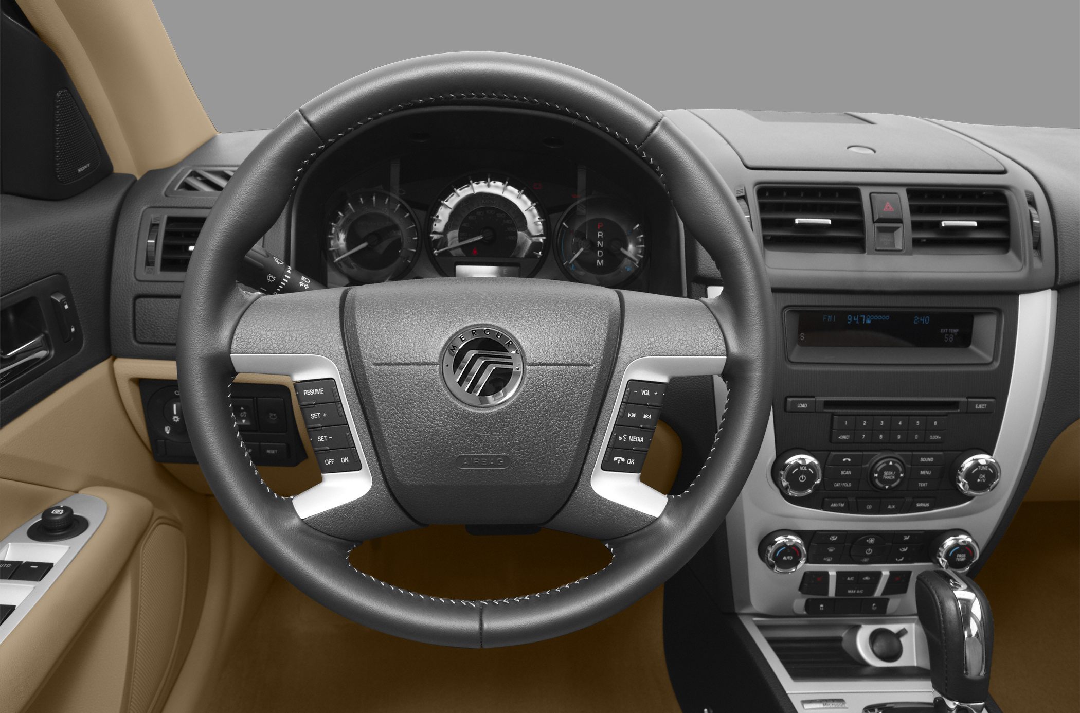 Steering wheel with control buttons and central dashboard with radio and climate controls