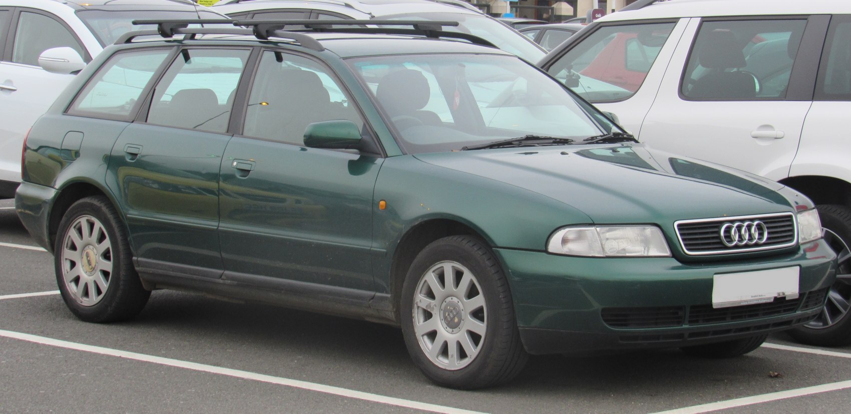 Green station wagon with roof rails and alloy wheels