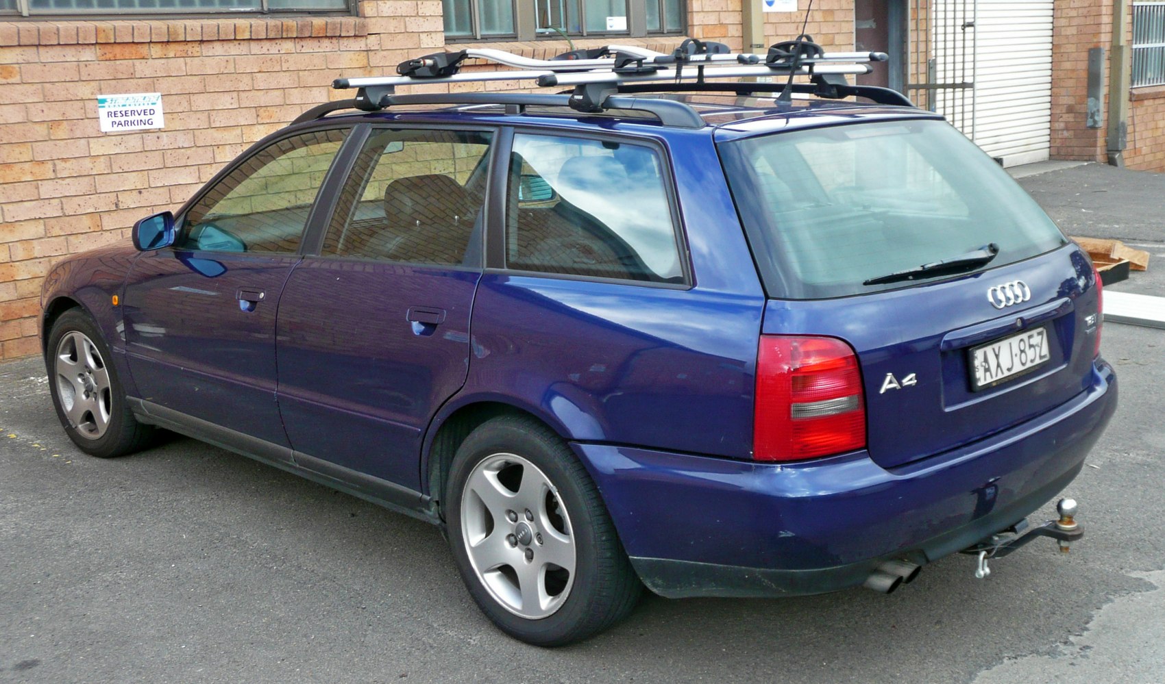 Blue station wagon with roof rack and rear tow hitch