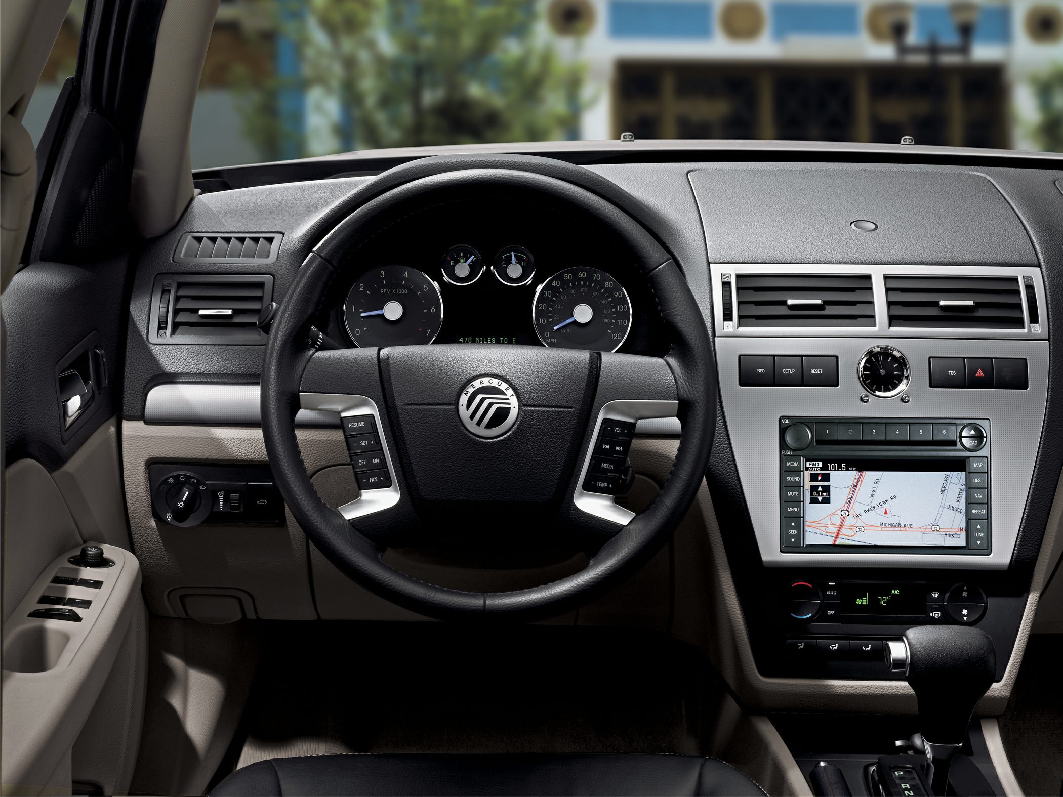 Steering wheel with controls and dashboard with GPS navigation