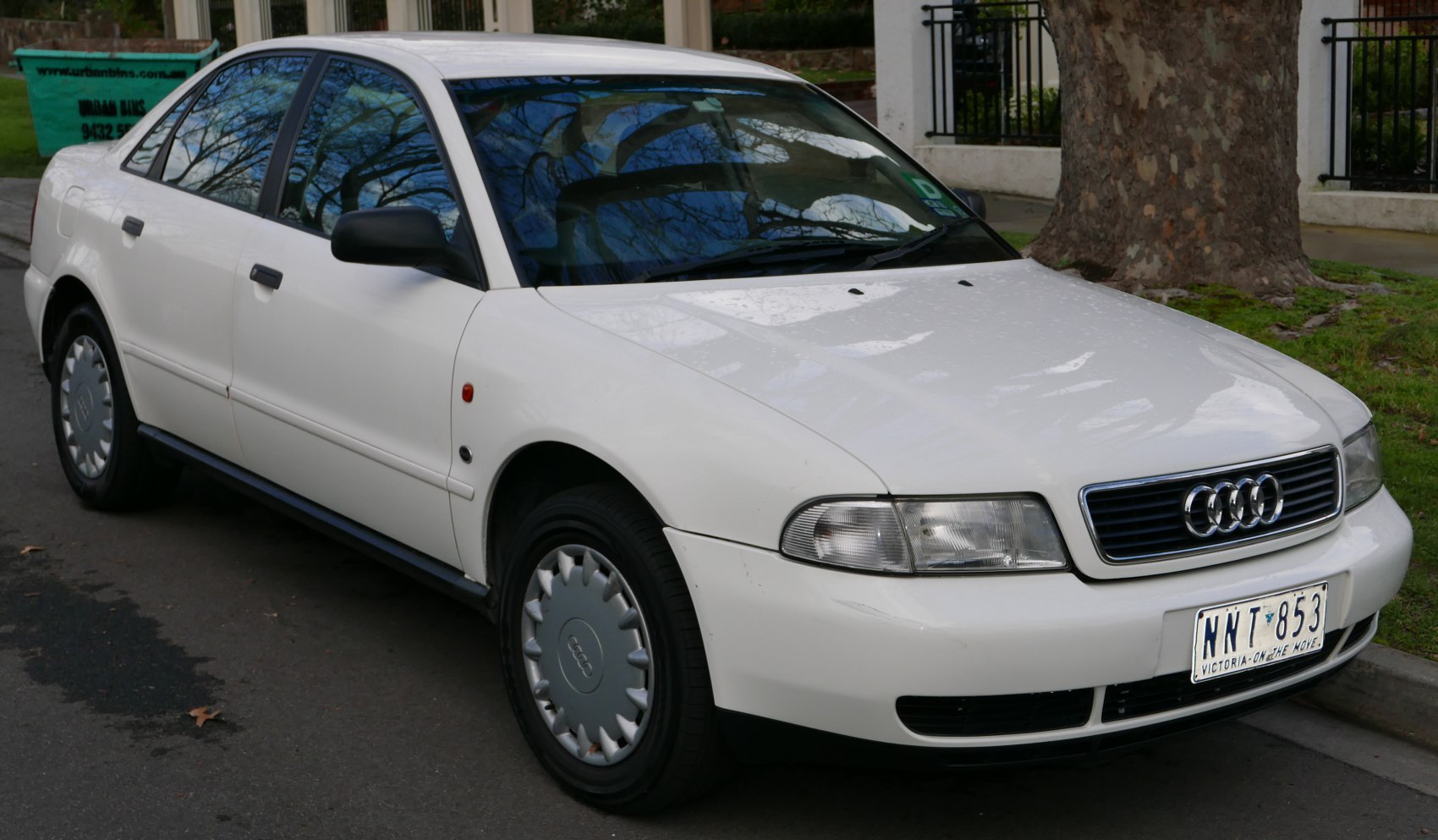Front and side view of a mid-90s sedan with specific grille and headlight design