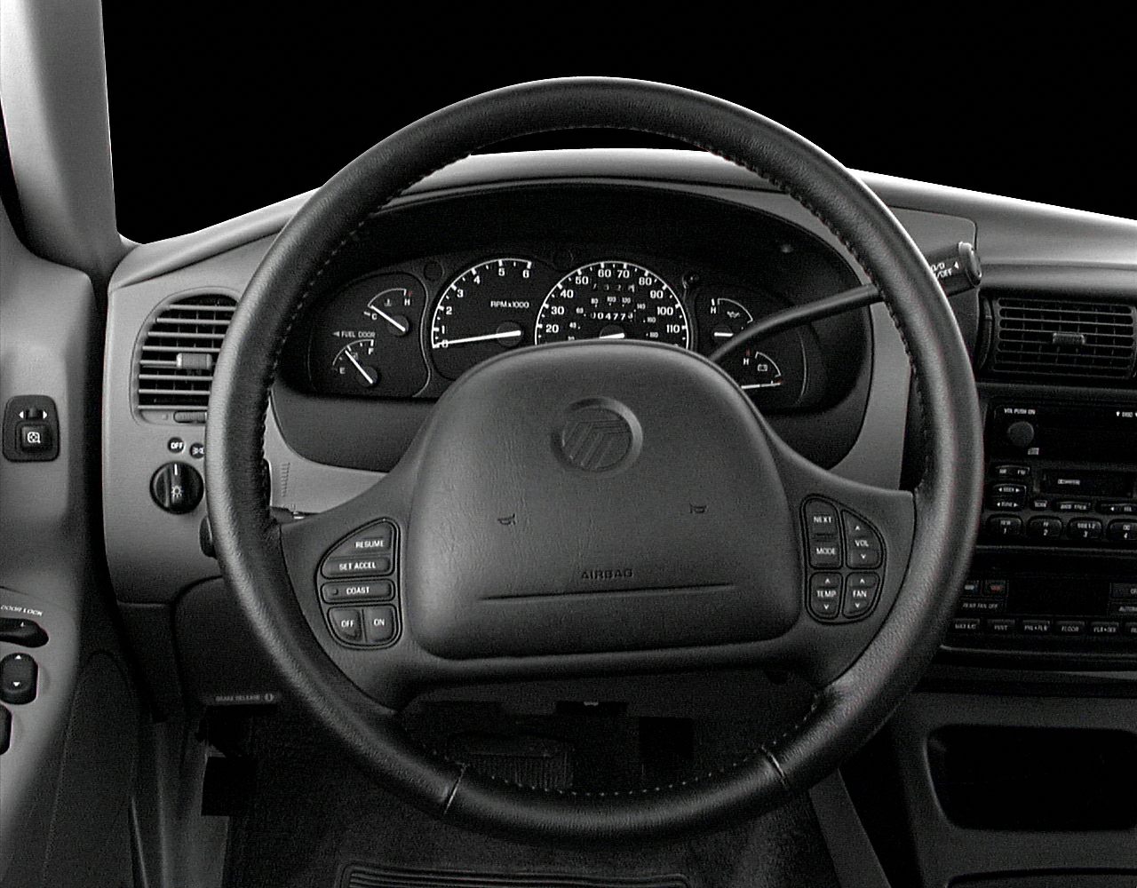 Steering wheel with functional control buttons and detailed instrument cluster