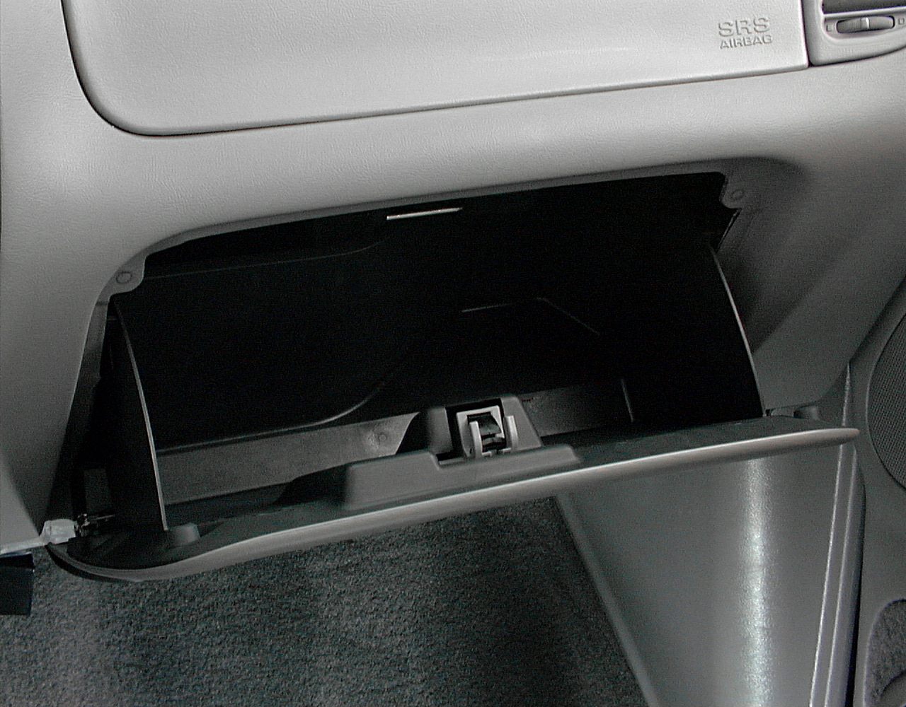 Open glove compartment with visible latch and dashboard section