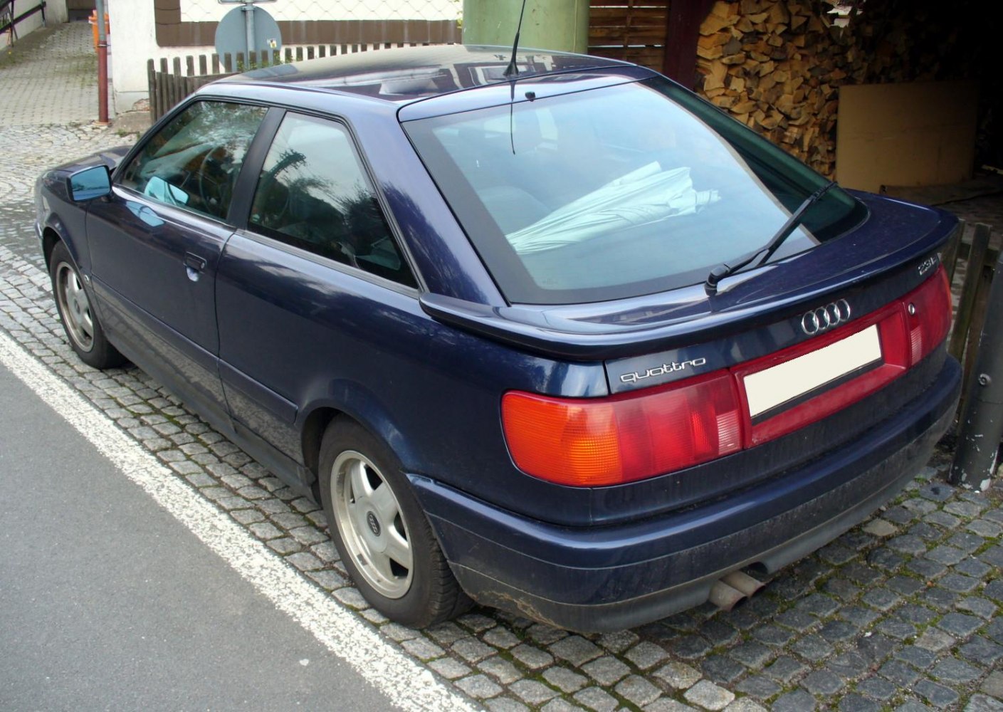 Rear view of sporty hatchback with distinctive taillights and rear window wiper
