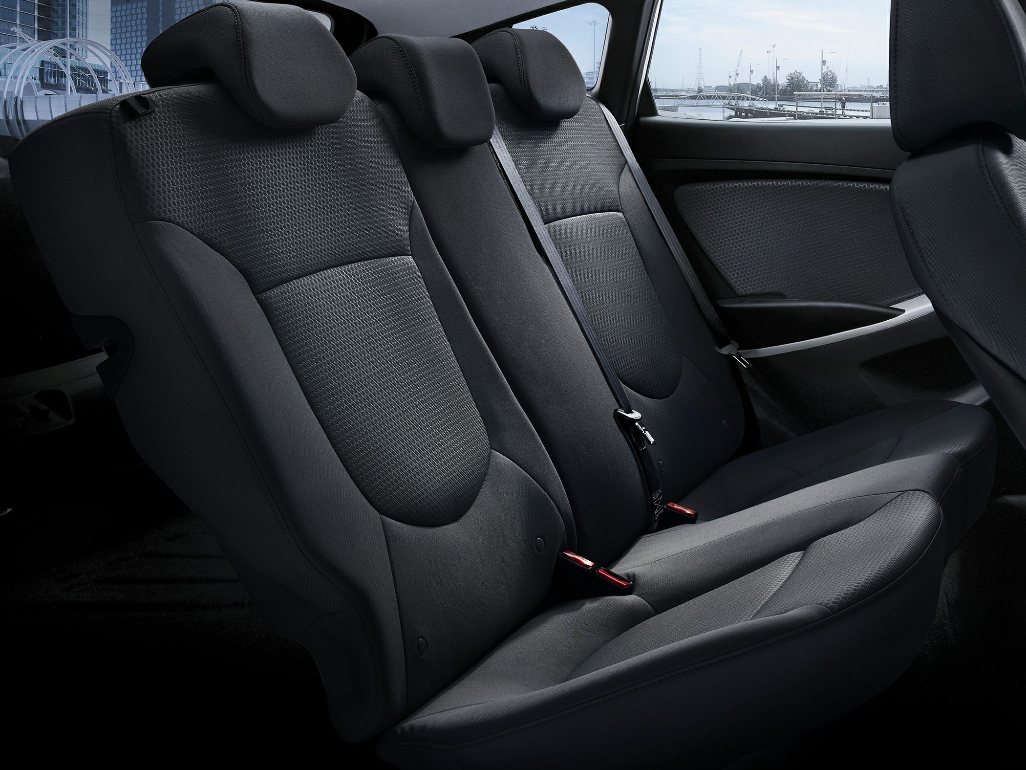 Rear seat interior with fabric upholstery and three headrests