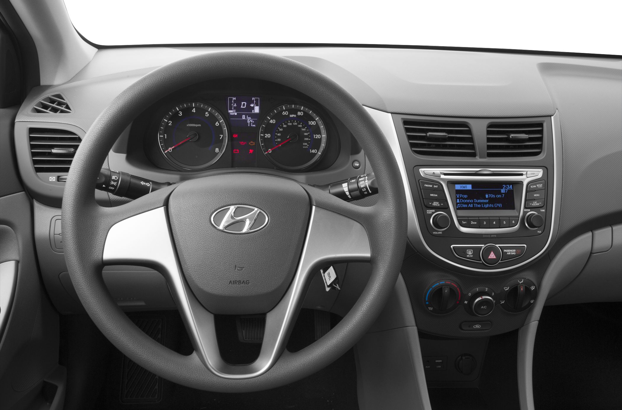 Steering wheel and dashboard with speedometer, tachometer, and radio display