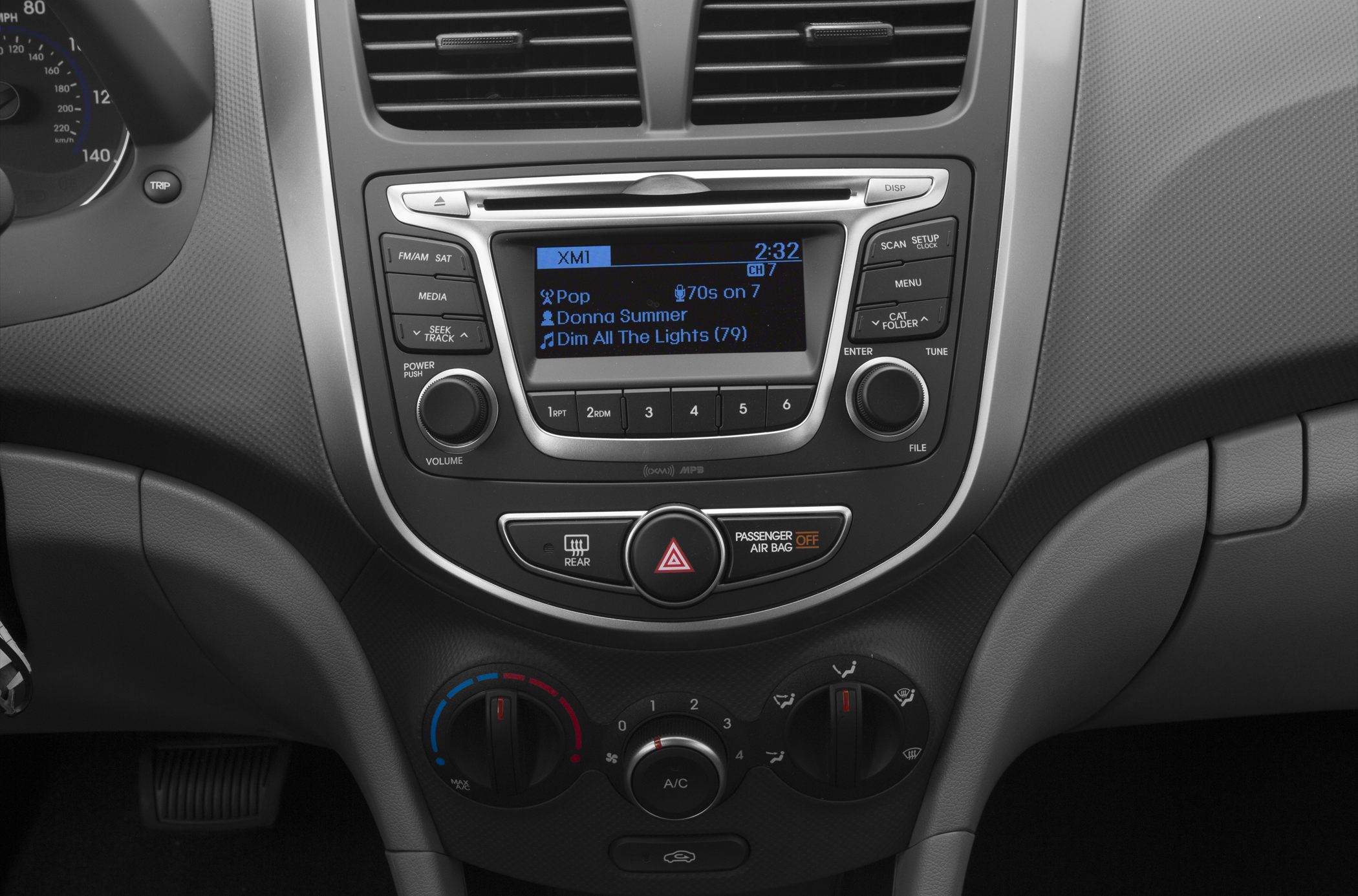 Car dashboard with radio display and manual climate control knobs