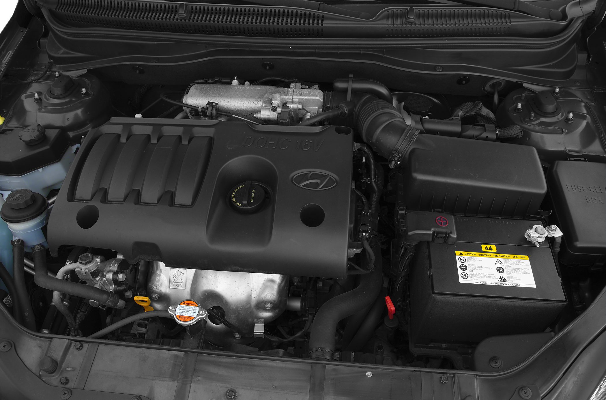 DOHC 16V engine layout with car battery and air intake components