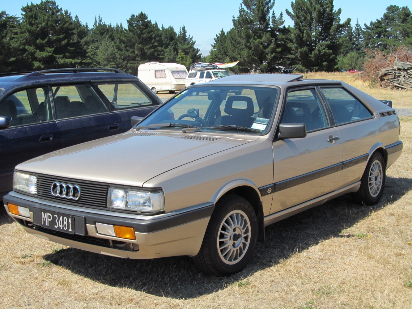 Two-door coupe with sunroof and alloy wheels.