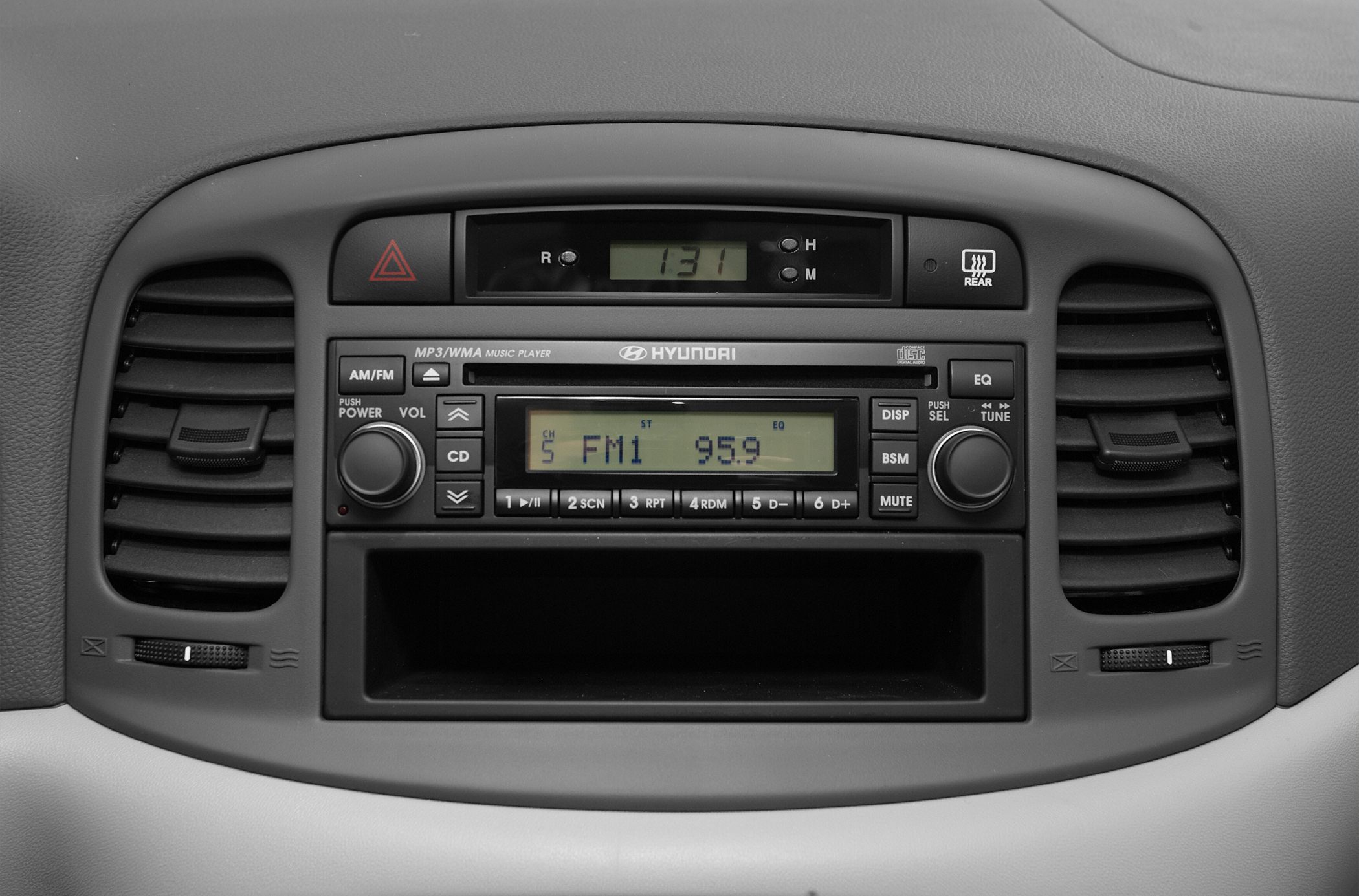 Car dashboard radio system with air vents and control knobs