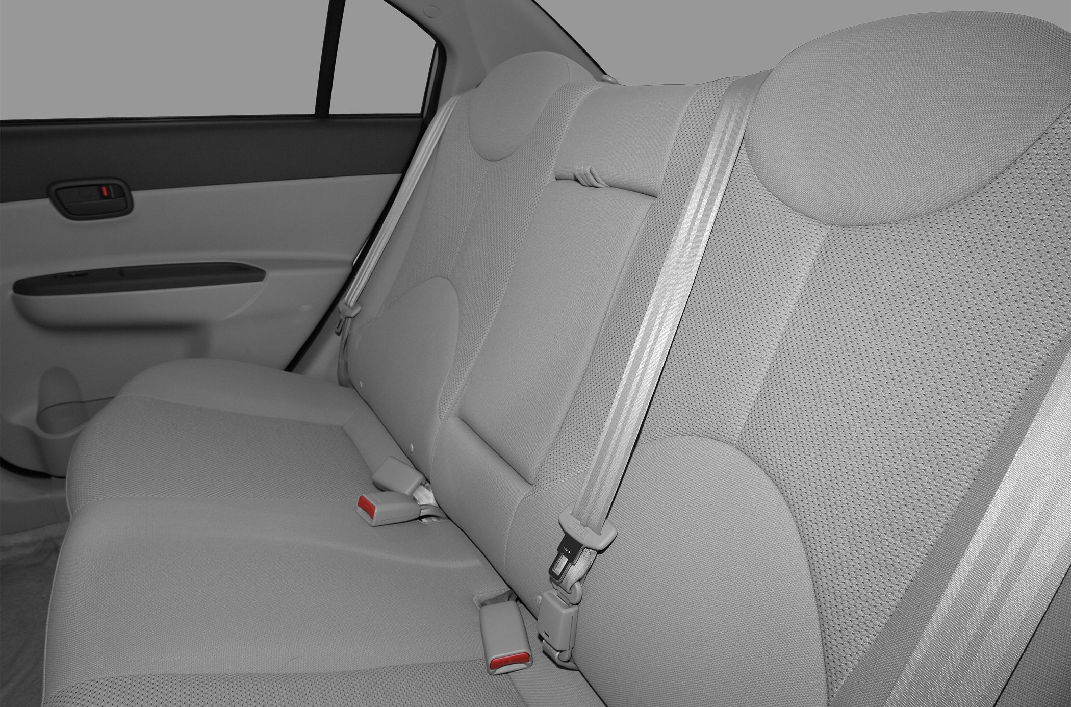 Rear passenger seats with seatbelts and fabric upholstery