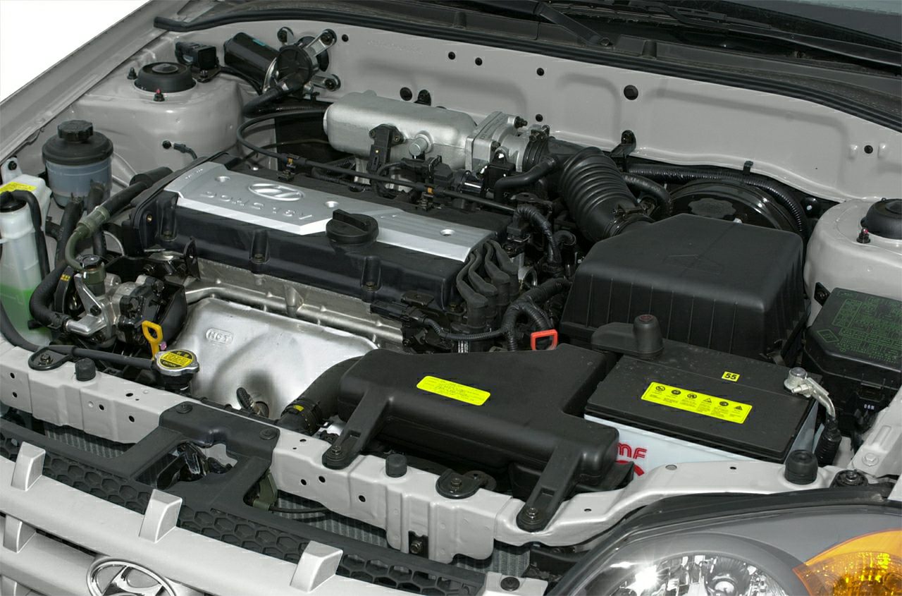 Close-up of a compact inline engine and engine bay components