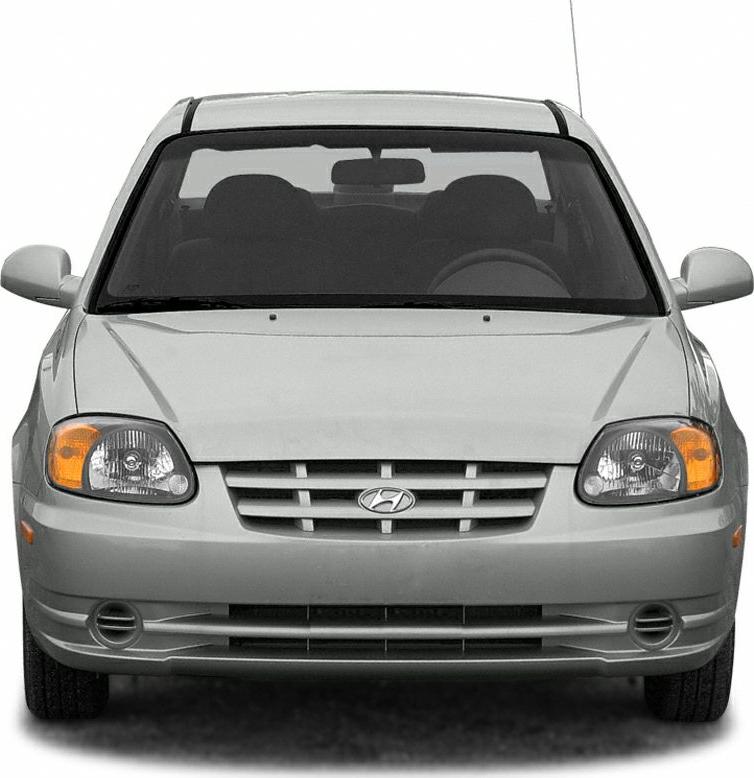 Front view of a car with grille, headlights, and fog lights