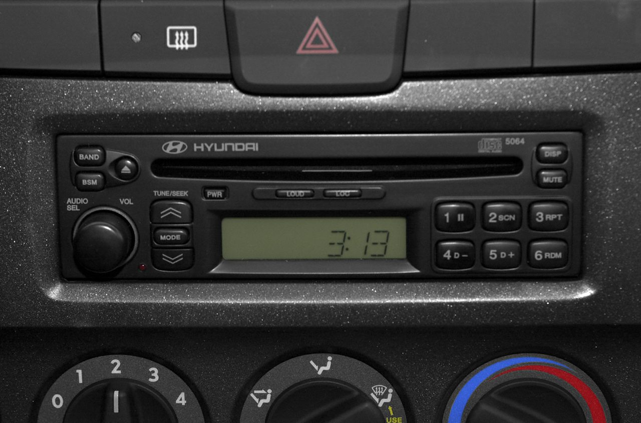 Car dashboard showing radio and manual climate control knobs