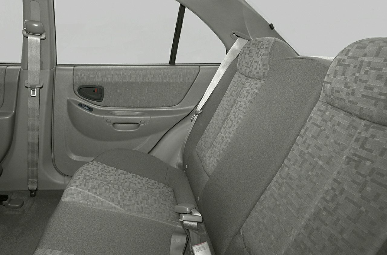 Rear seat fabric upholstery and door panel with seat belts