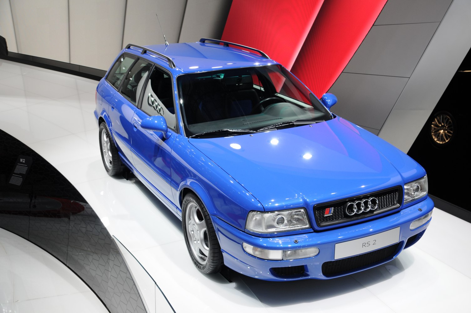 Bright blue high-performance station wagon with sporty wheels and roof rails