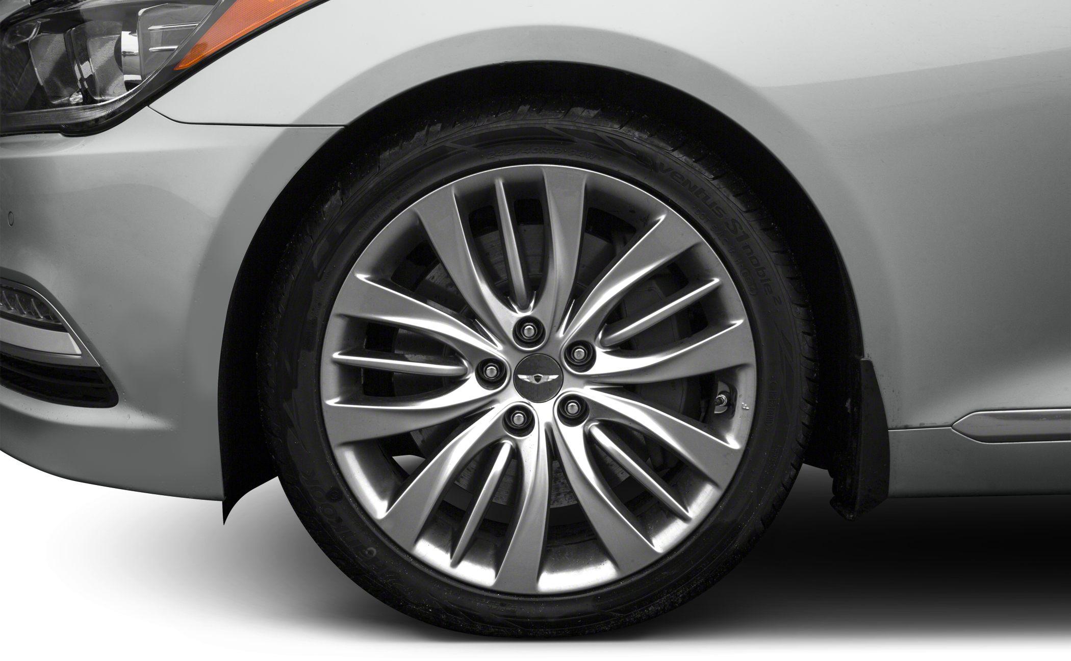 Close-up of silver alloy wheel with unique multi-spoke design and partial front fender