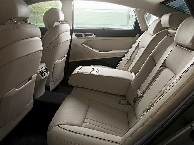 Beige leather rear seat with armrest and climate vents