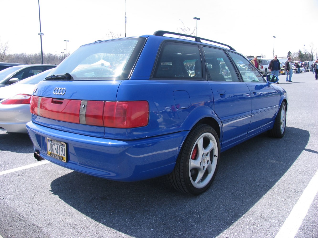 Rear and side profile of blue sporty wagon with distinctive taillights and alloy wheels