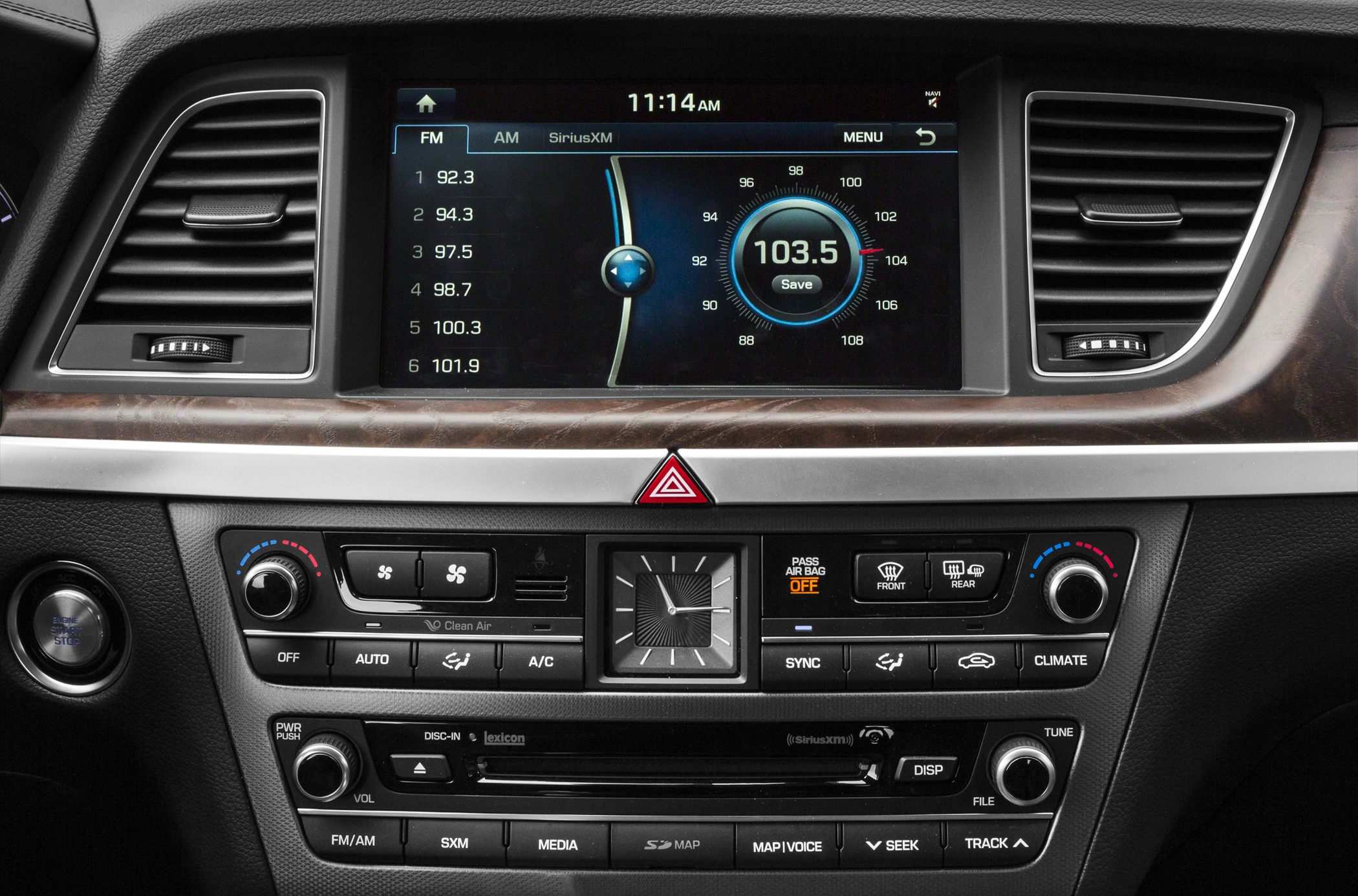 Car infotainment touchscreen and dual-zone climate controls with analog clock