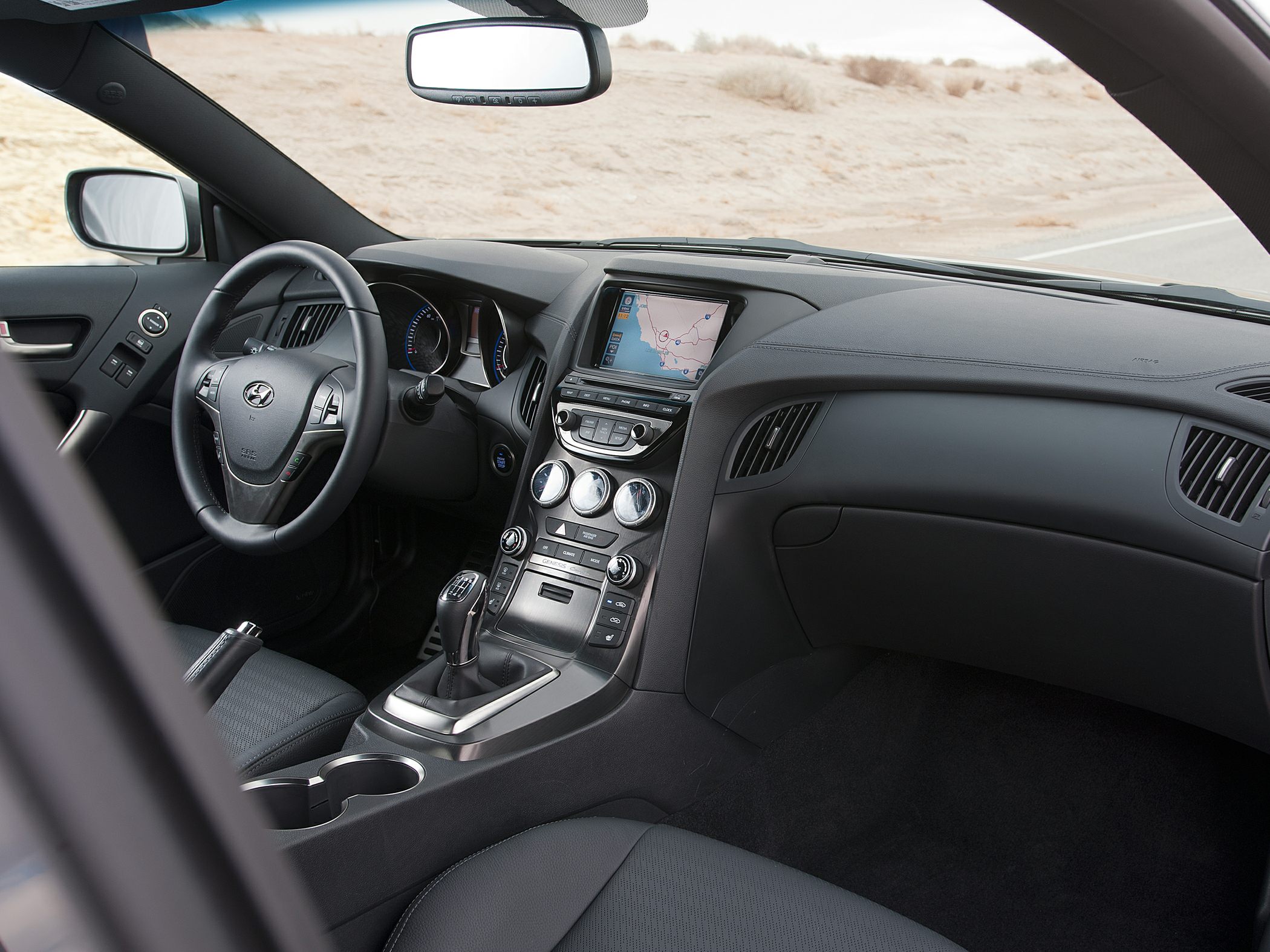 Modern car interior with touchscreen, dashboard, and manual gear shift