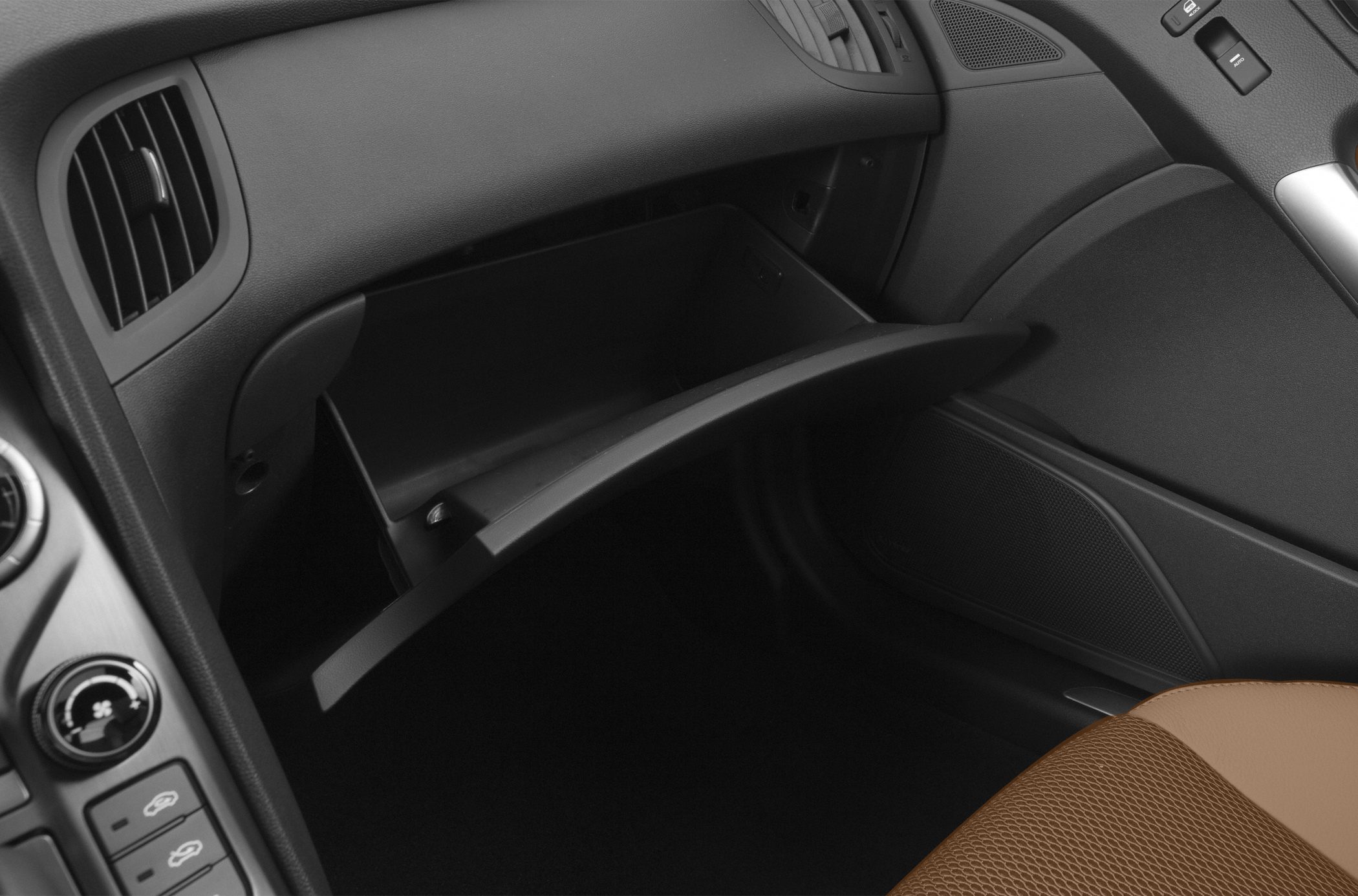 Open glovebox compartment with adjacent dashboard air vent and controls
