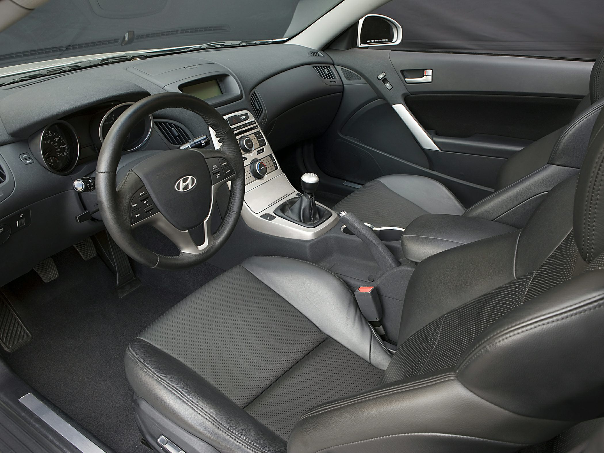 Manual transmission and leather seating in a sleek car interior