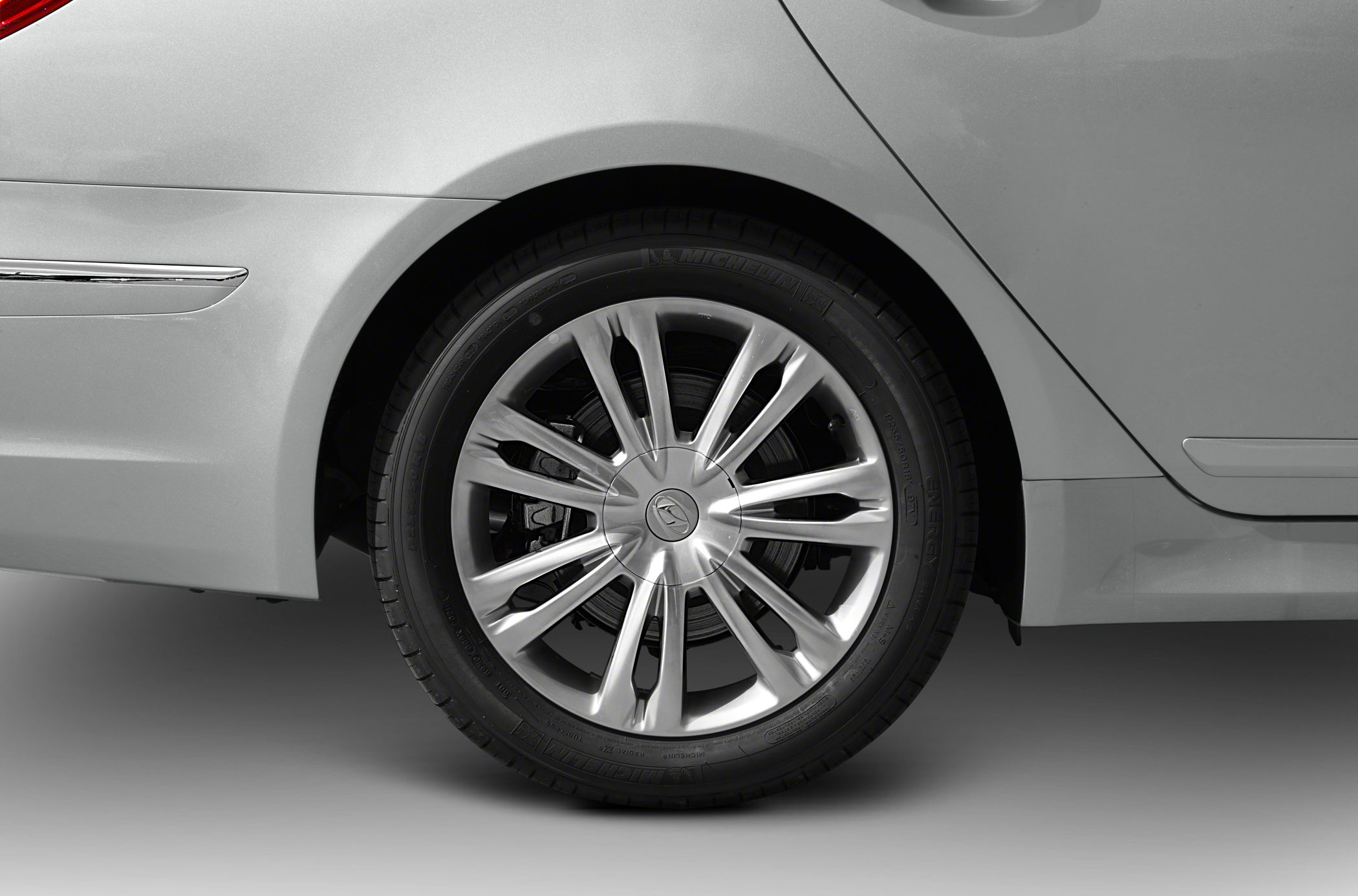 Close-up of rear alloy wheel and adjacent rear quarter panel.