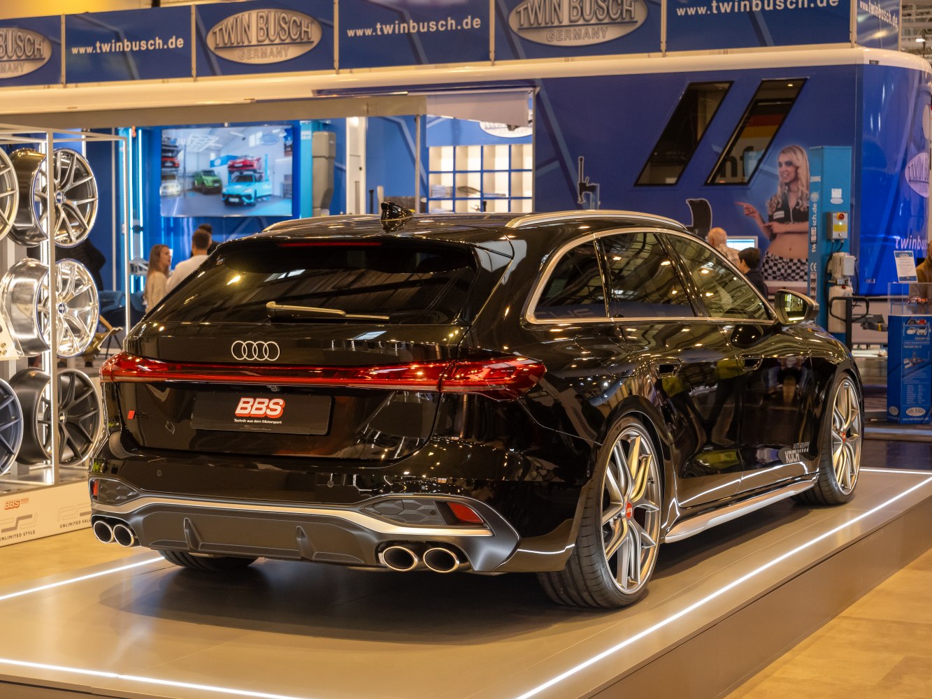Rear view of a sporty station wagon with quad exhausts and LED taillights