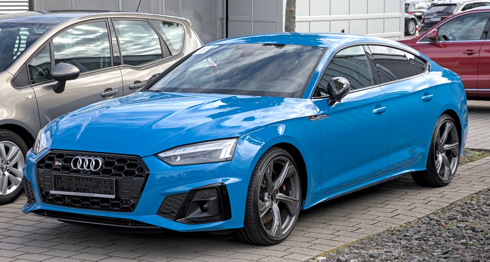 Blue hatchback with aggressive front grille and alloy wheels