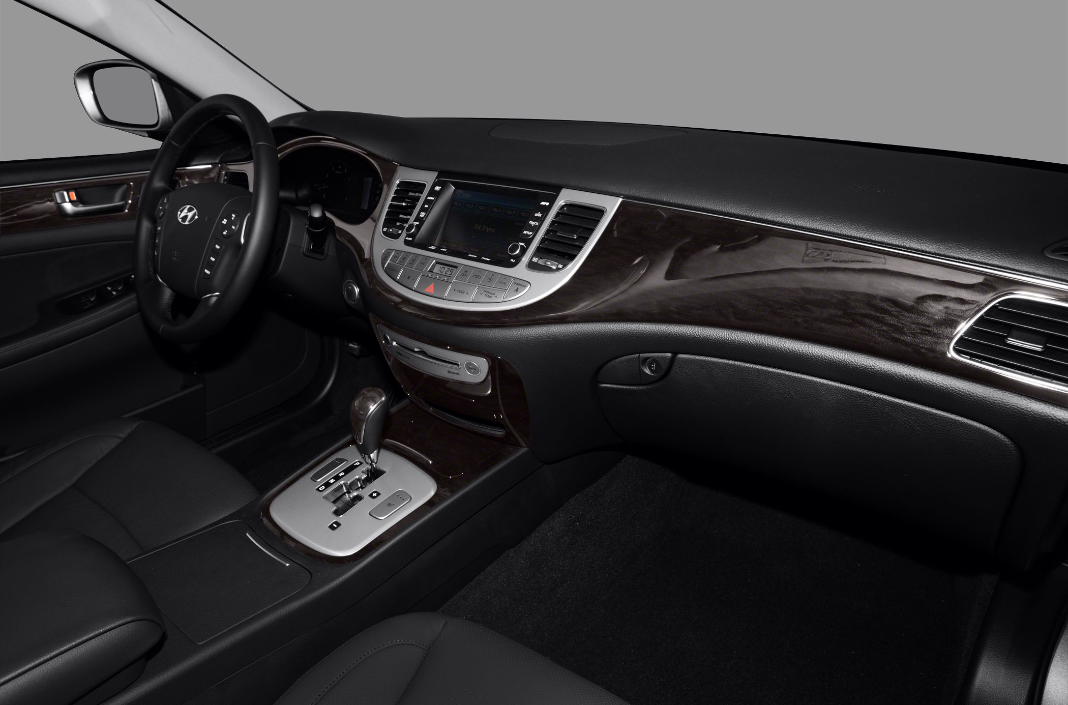 Car interior with dashboard, steering wheel, and center console with automatic gear shift
