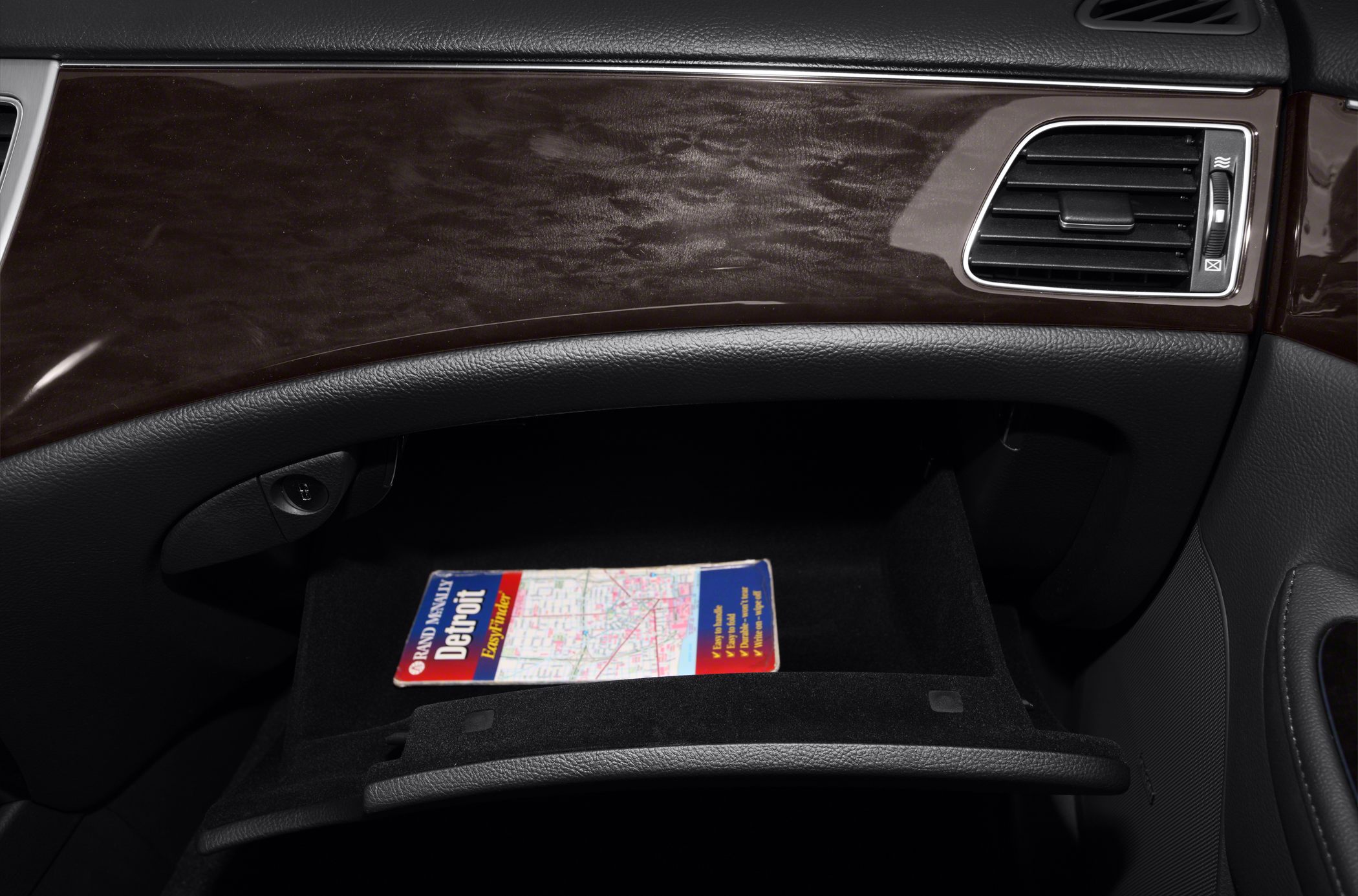 Open glove box with wood trim dashboard