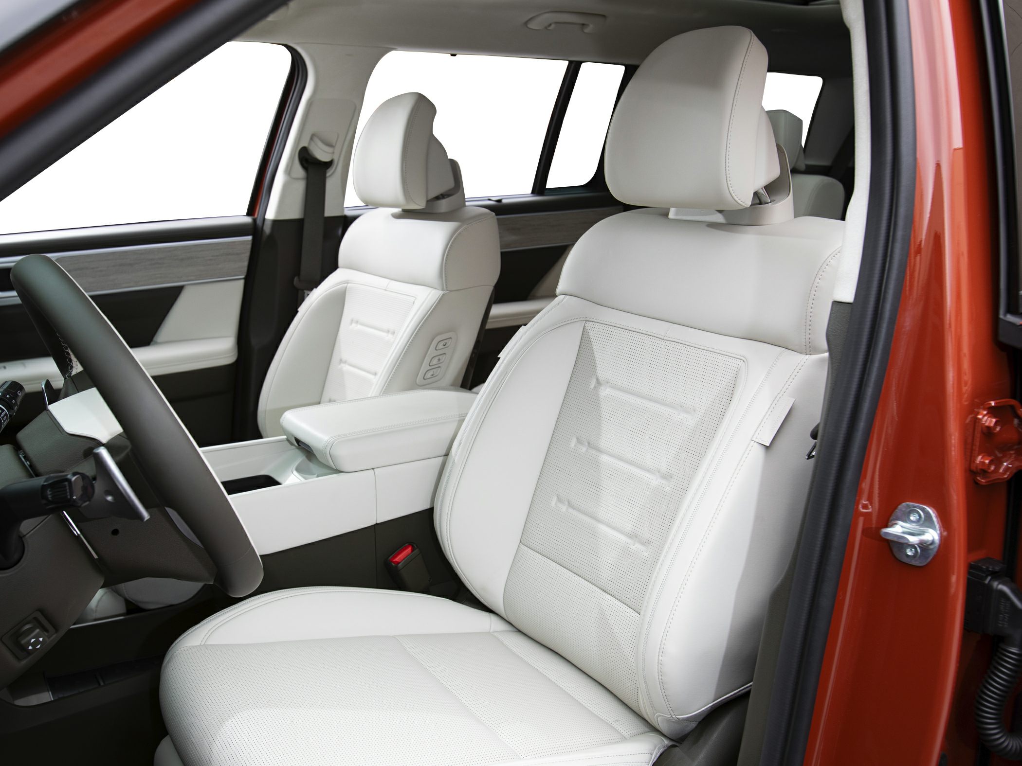 White leather front seats with adjustable headrests and modern armrest