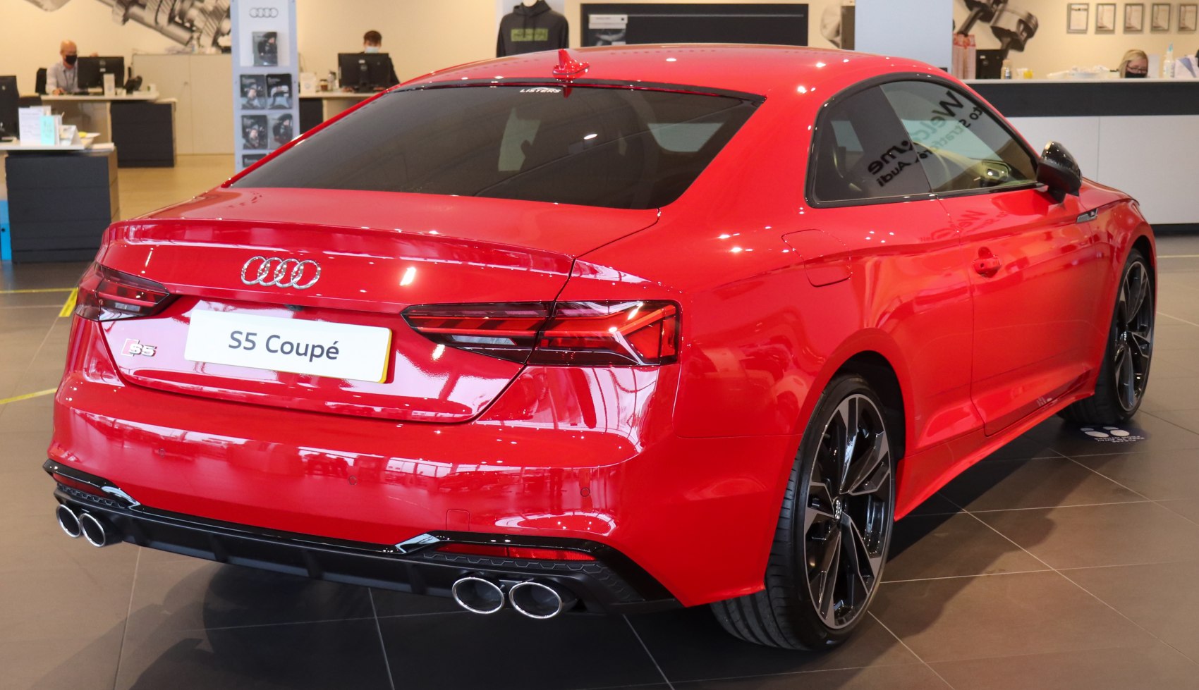 Red coupe rear with quad exhaust and sleek LED taillights
