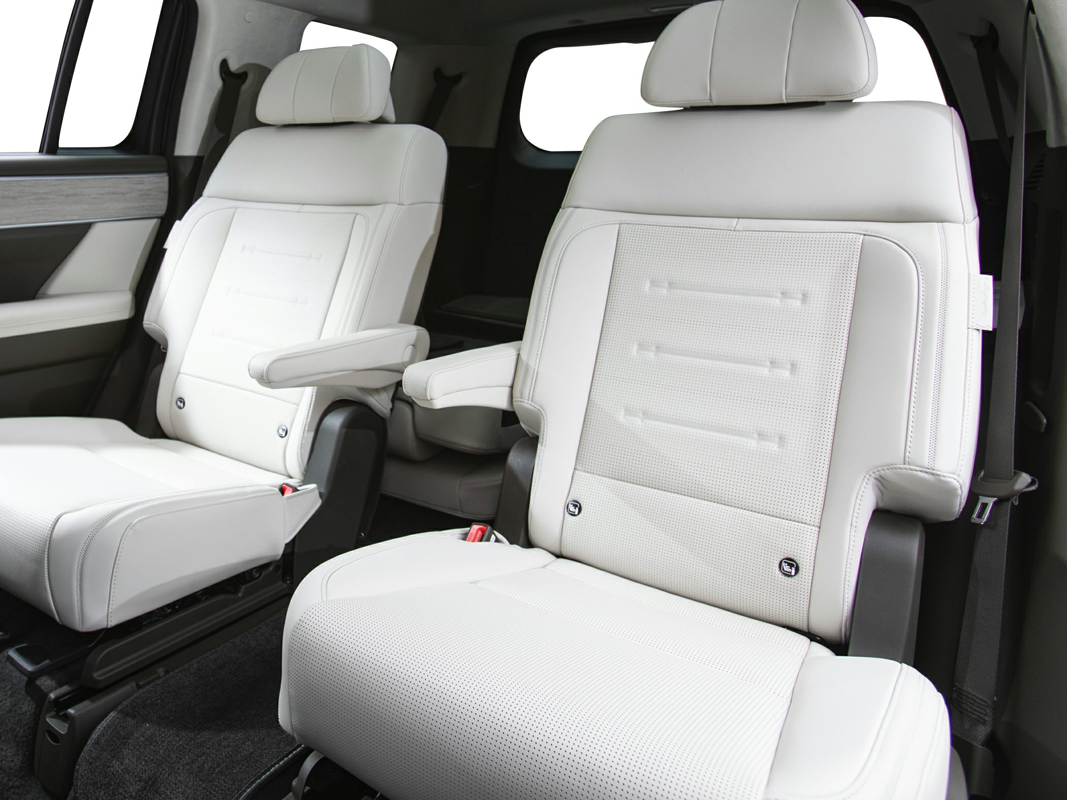 White leather captain seats with armrests in a modern car interior