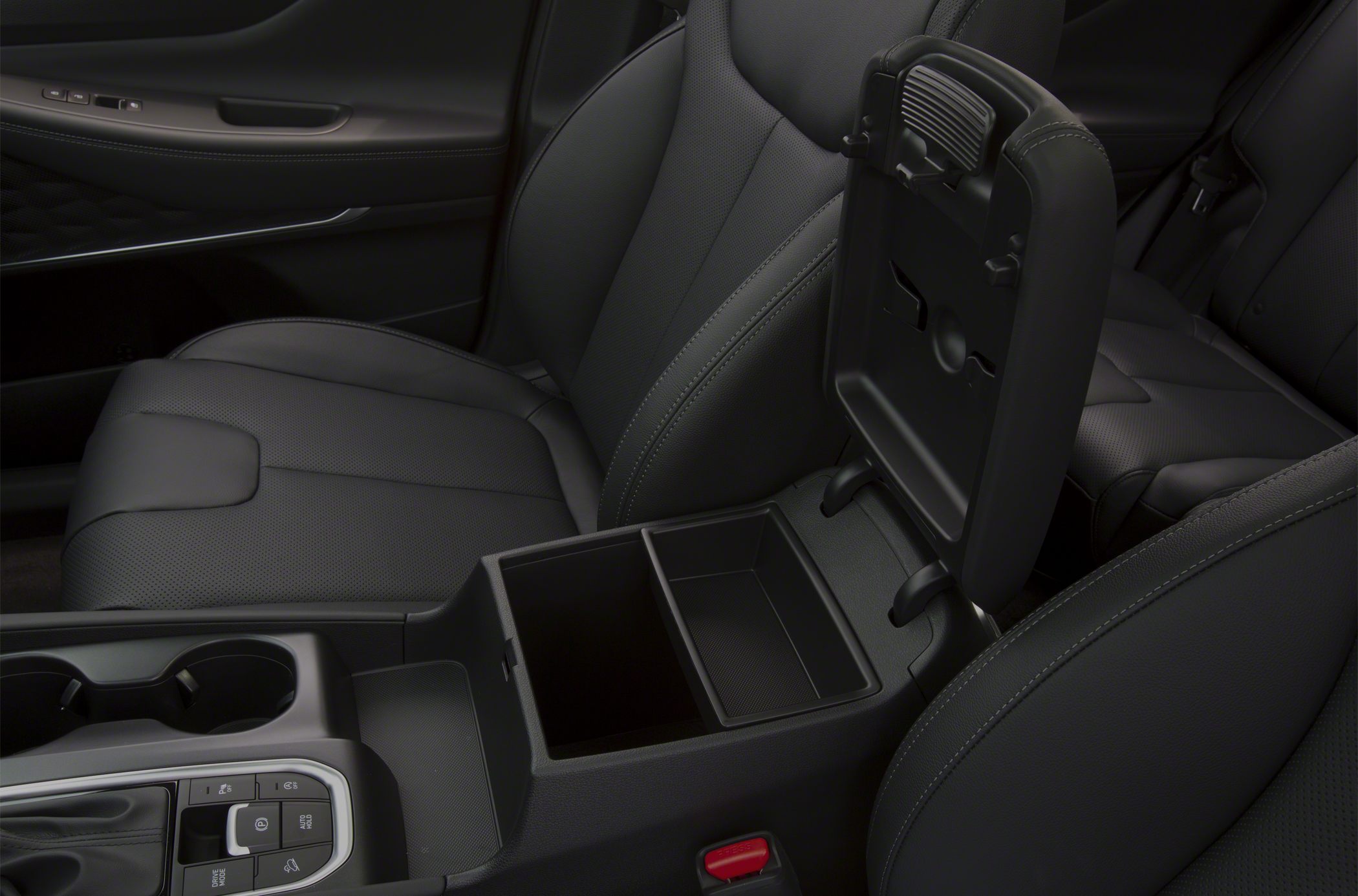 Center console storage with black leather seats and detailed stitching