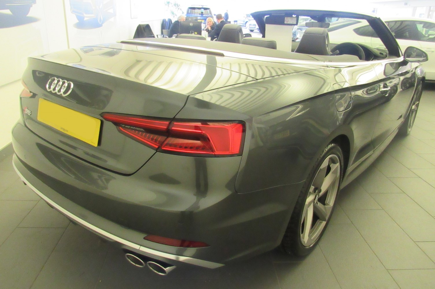 Rear view of convertible with dual exhaust and modern tail lights