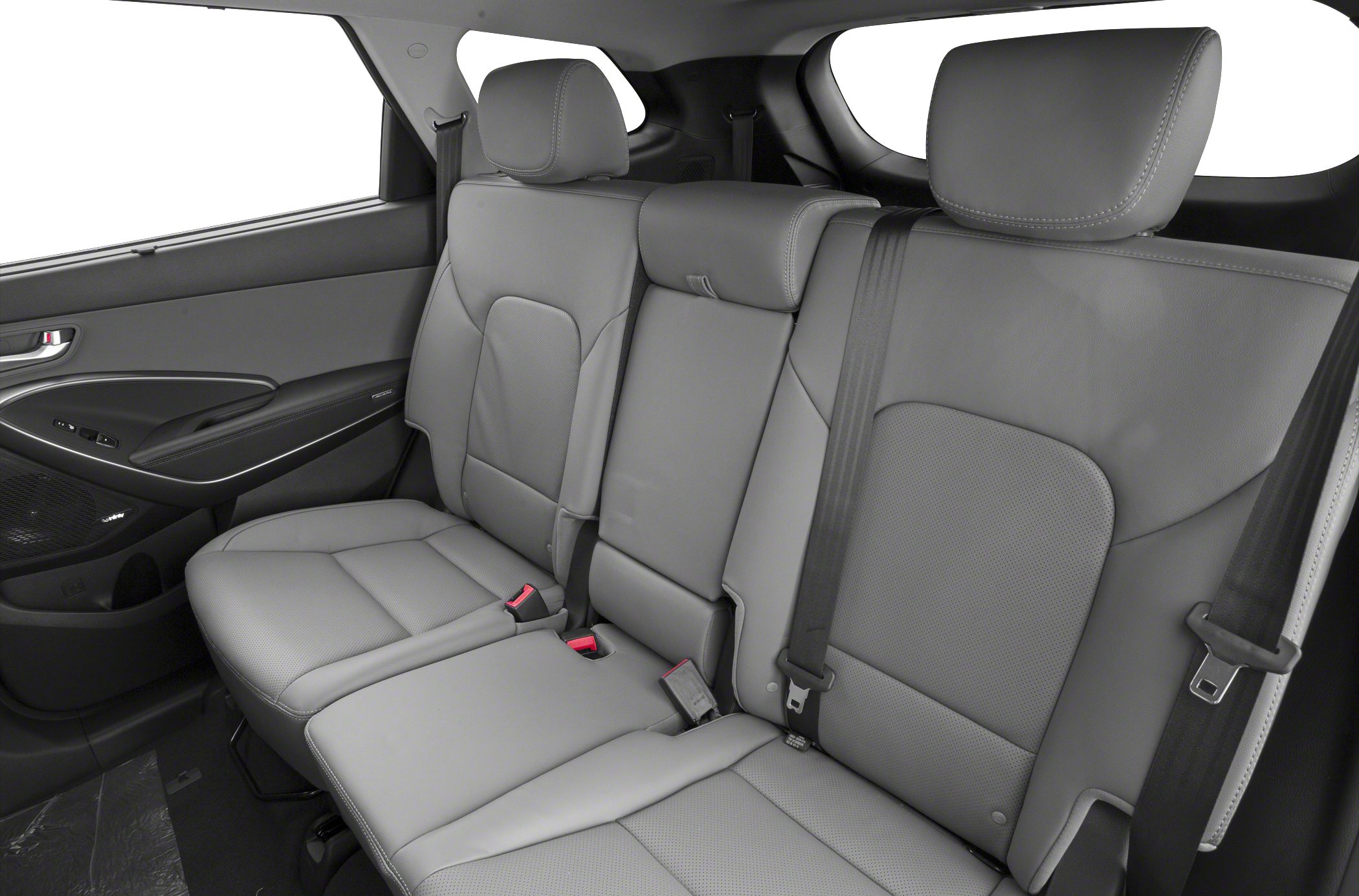 Spacious rear seats with leather upholstery, headrests, and seat belts.